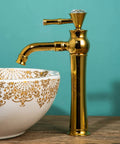 Gold Tall Vessel Sink Faucet With Single Lever Handle One Hole Deck Mount Vanity Mixer Tap For Bathroom next to a decorated basin