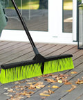 24-inch push broom with 63-inch handle used for sweeping leaves on patio, part of Three Pack 24 Inch Push Brooms Workhorse Outdoor Brooms