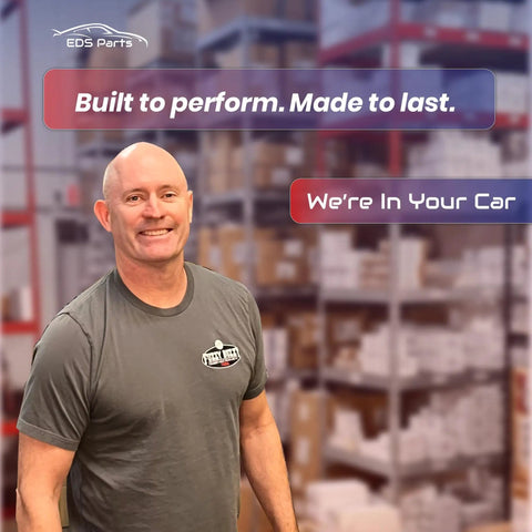 Image of a smiling man in a gray shirt standing in a warehouse with shelving behind him, promoting EDS Parts.
