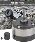Planetary Gearbox Reduction Motor For RC Cars And Trucks on rocky terrain showcasing output shaft and all-metal gear.