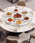 Massive 47 Inch Clear Tempered Glass Lazy Susan Turntable With Killer Smooth Swivel Rotation displaying meals on a dining table.