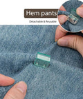 Close-up of a 20 Pairs Quick Fix Hem Clips and Reusable Clamps for Pants, Paper and Window Ventilation on denim fabric.
