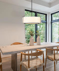 Grab This 20 Inch Drum Chandelier With 5 Lights For Instant Modern Farmhouse Vibes Featuring Soft White Linen Shades And Sleek Black Frames, illuminating a dining table.