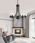 Living room with Five Light Matte Black Farmhouse Industrial Chandelier With Clear Glass Shades, fireplace, and modern decor.