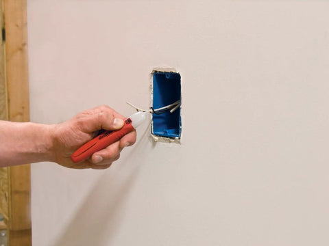 Two Piece Electrical Safety Kit With Non Contact Voltage Tester And GFCI Outlet Tester in use detecting voltage in wall