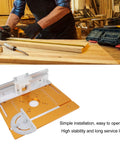 Front view of orange aluminum router table insert plate with measurement scales, central hole, and mounting bracket.