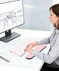 Woman typing on computer with Clear Acrylic Tilted Keyboard Stand For Ergonomic Typing Low Front Lip Keeps Your Keys In Place.