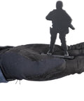 Gloved hand holding Big Bang Steel Target for Airguns Standing Soldier Popper 6 Pack Heavy Duty Plinking Target with Audible Ping and Easy Manual Reset Pre Drilled Mounting Holes for Quick Setup.