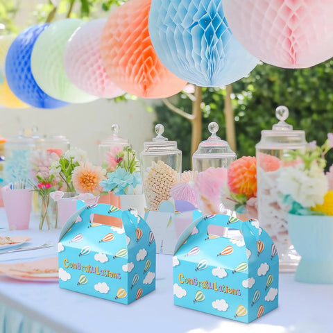 24 Pack Graduation Gift Boxes With Handles Colorful Hot Air Balloon Pattern Fun Treat Boxes For Candy Kindergarten Through College Party Decor And Supplies on a decorated table with flowers and colorful balloons.