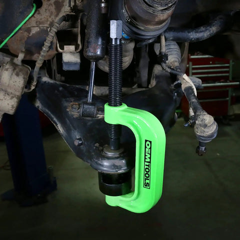 XL C Frame Ball Joint Press Kit For Trucks in use on a vehicle suspension system in a garage setting
