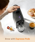 Person using Upgrade Bafe Pro Espresso Machine For Nes Original Pods At Home 20 Bar Pump Fast Extraction Espresso And Lungo Coffee Maker With One Touch Operation And Barista Level Crema Black Finish on counter with bread and coffee cup