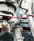Hella Tough Brake Caliper Hooks With Thick Rubber Pads For Straightforward Disc Service And Pro Level Suspension Overhauls Set Of Two Bright Red Clamps securing brake components in a vehicle.