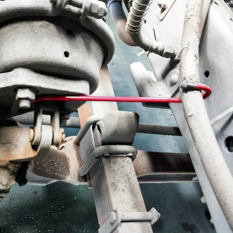 Hella Tough Brake Caliper Hooks With Thick Rubber Pads For Straightforward Disc Service And Pro Level Suspension Overhauls Set Of Two Bright Red Clamps securing brake components in a vehicle.