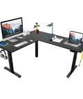 Boss Level L Shaped Electric Standing Desk With Smooth Glide Motors And Three Memory Presets For A Sick Gaming Station Or Remote Work Hub In Sleek Black Finish. L-shaped desk with dual monitors, laptop, and accessories.