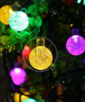Solar Outdoor String Lights With 60 LED Crystal Globe Bulbs 8 Modes 26ft Waterproof Fairy Lights glowing in multicolor