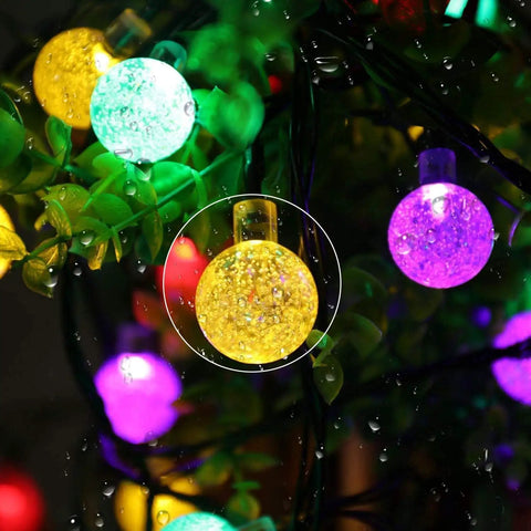 Solar Outdoor String Lights With 60 LED Crystal Globe Bulbs 8 Modes 26ft Waterproof Fairy Lights glowing in multicolor