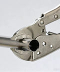 Close-up of Premium Steel Locking Pliers With Wire Cutter gripping a metal pipe for secure fastening.
