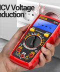 Red All In One Digital Multimeter Tester for Home Auto and DIY Projects measuring NCV against a wall outlet.