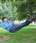 Army Green Outdoor Travel Hammock With Mesh Net Nylon Rope Construction in use by person relaxing between trees