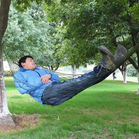 Army Green Outdoor Travel Hammock With Mesh Net Nylon Rope Construction in use by person relaxing between trees