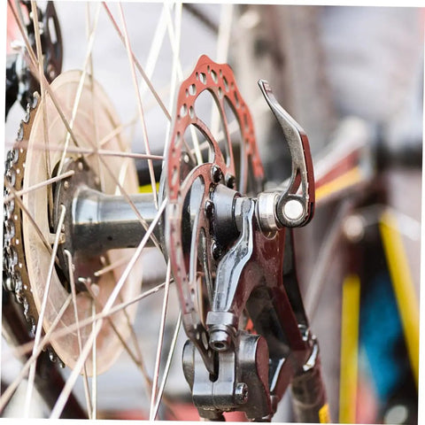 Complete Mechanical Disc Brake System For Mountain Bike Front And Rear With Forged Aluminum Calipers And Long Wear Pads That Give You Dang Serious Stopping Power On Gnarly Downhills Without Breaking The Bank, close-up of rear brake caliper and rotor.