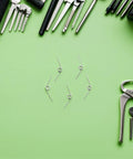 Yardwe 16pcs Premium Trash Can Torsion Spring Replacement Kit For Kitchen Bin Lid Fix With Card Slot And Foot Pedal Integration Durable Silver Metal Parts For Quick Diy Repair And Home Upgrades, silver torsion springs on green background