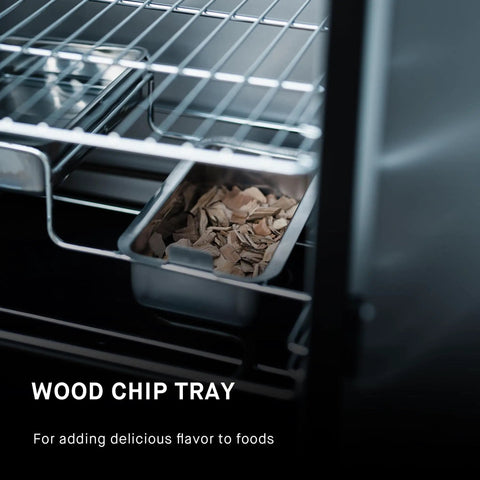 Wood chip tray inside Electric Vertical BBQ Smoker With Analog Temperature Control 30 Inch Black Unit Featuring 535 Sq In