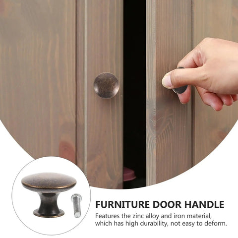 Hand using 12 Pack Round Antique Brass Cabinet Pulls Single Hole Small Flat Head Metal Drawer Handles For Kitchen And Bath Cabinets Replacement Retro Furniture Knobs Hardware on a wooden cabinet.