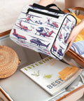 Person packing Aircraft Pattern Travel Toiletry Bag For Women And Men, Large Capacity 10.2 x 6.5 x 9.2 Inches into suitcase