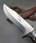 Close-up of M390 Fixed Blade Hunting Knife With Wood Handle Full Tang Survival Knife Leather Sheath Built For Rugged Outdoor Camping Bushcraft And Beast Mode Wilderness Tasks No Cap, showing blade engraving and leather sheath.