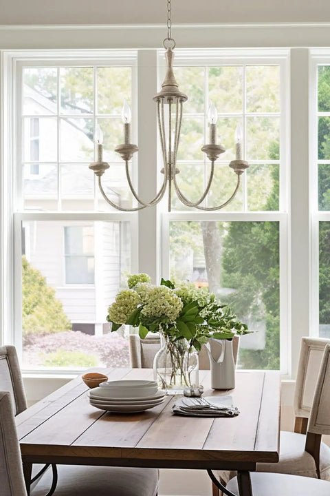 5-Light French Country Chandelier With Adjustable Height In Smoked Cedar And Rustic Metal Finish hanging over dining table.