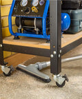 Heavy Duty Shop Vacuum Floor Sweep Attachment With Flexible Swivel Head And Angled Neck Designed To Scoop Sawdust And Floor Grit Under Workbenches on a workshop floor.