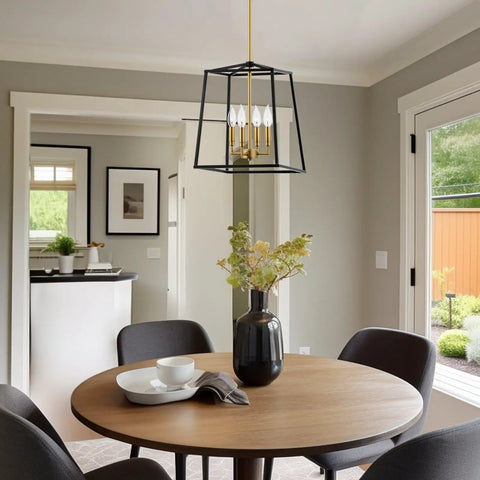 16 Inch 4 Light Modern Black Lantern Pendant Light With Warm Brass Accents in dining room over round table with chairs