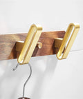 Heavy Duty Solid Wood Wall Hooks Slick Brushed Gold Finish Double Arm Coat Rack close-up of hooks on wooden base.