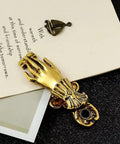 Gold Lady Hand Shaped Paper Clips With Dope Retro Style Binder Clips for junk journals, shown on a notebook page.