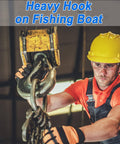 Worker using heavy hook on fishing boat deck, wearing safety gear, illustrating use of One Quarter Inch Safety Chain Hooks With Clevis Slip Hook And Safety Latch, Grade 70 Forged Steel, 12,600 Lb Capacity For Trailers And Trucks, Heavy Duty Tow Winch Hook Set, 2 Pack in rugged environments.