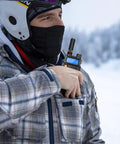 Person using dual band VHF UHF ham radio antenna SMA female short stubby in snowy outdoor setting for portable communication