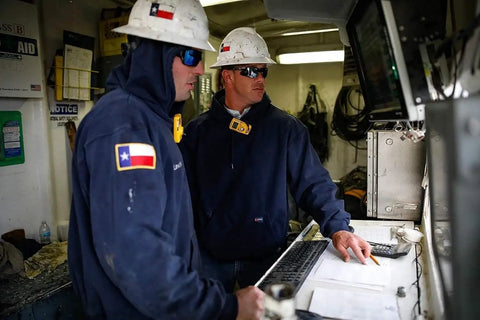 Hella Comfy Mens Flame Resistant Hoodie Sweatshirt With Heavyweight 12 5 Oz Fleece Pullover For Tough Industrial Job Site Work Wear Navy Cotton Acrylic Blend Meets Nfpa Atptv Hrc Safety Specs Xl Regular worn by workers in helmets and safety glasses.