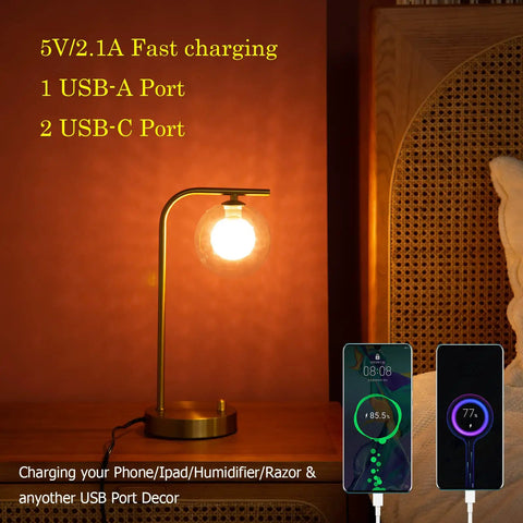 Industrial Glass Globe Desk Lamps Set Of 2 With USB Charging Ports Gold Metal Bedside Table Lamps Stepless Dimmable Brightness Perfect For Living Room Or Bedroom LED Bulbs Included, shown on bedside with phones charging.