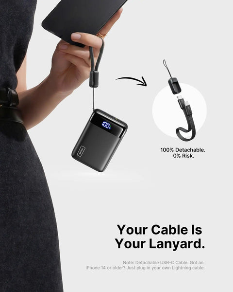 Ultra Compact 20000mAh Power Bank Featuring Dual USB Cables And Secure Lanyard Offers Beast Mode 22.5W Fast Charging, held with detachable lanyard.