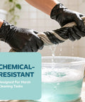 Hands wearing Solid Black Nitrile Gloves One Hundred Count Large Heavy Duty Powder Free Latex Free Badass Utility Gear squeezing a wet rope.