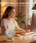 Compact Desk Fan On The Go Quiet Rechargeable Mini Fan with 4 Speeds LED Display on desk next to woman working