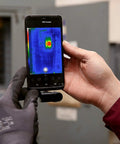 Compact All Purpose Thermal Imaging Camera For Android USB C Turns Your Phone Into A Real World Thermal Cam For Home Jobsite And More Spot Energy Loss Electrical And Mechanical Faults Water Damage And Hidden Issues attached to a phone in use