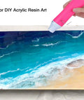 Bubble Removing Heat Gun For Epoxy Resin And Acrylic Art Crafts in use on a blue and sand-colored resin artwork, pink tool.