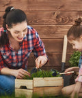 All In One Bonsai And Succulent Care Kit With Ergonomic Shovel And Scissors, Pouring Kettle, Seedling Tools For Indoor Potted Plants, Easy Transplanting, Pruning, Watering, And Plant Maintenance. Mother and child using small garden tools in a wooden planter