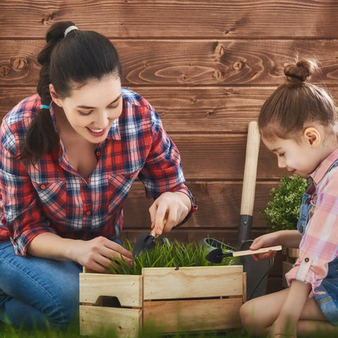 All In One Bonsai And Succulent Care Kit With Ergonomic Shovel And Scissors, Pouring Kettle, Seedling Tools For Indoor Potted Plants, Easy Transplanting, Pruning, Watering, And Plant Maintenance. Mother and child using small garden tools in a wooden planter