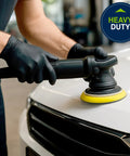 Person using Built Tough Black Nitrile Exam Gloves 5.1 Mil Heavy Duty Powder Free Disposable for auto detailing work.