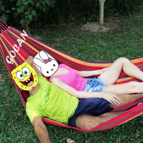 Extra Large Double Hammock For Two With 330cm Total Length And 500lb Capacity Canvas Cotton Super Comfy Outdoor Living For Patio Porch Garden Outdoor Indoor Rainbow XXL in use