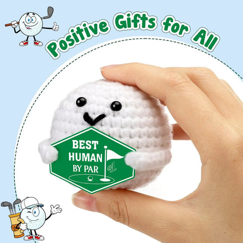 Hand holding crochet golf ball accessory with 'Best Human by Par' sign, part of Crochet Golf Ball Accessories Gift Set For Men Funny Golf Themed Gift For Him Fathers Day Birthday Or Graduation Ideal Gift For Dad Boyfriend Boss Coworker Son Grandpa Great For Retirement Parties Boss Gifts And Team Celebrations.