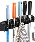 Wall Mounted Broom And Mop Organizer With Five Ball Slots And Six Hooks, Easy Install, Durable ABS Plastic, black color, holding tools.